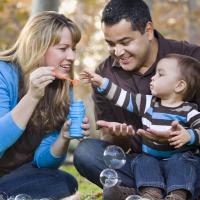 family blowing bubbles